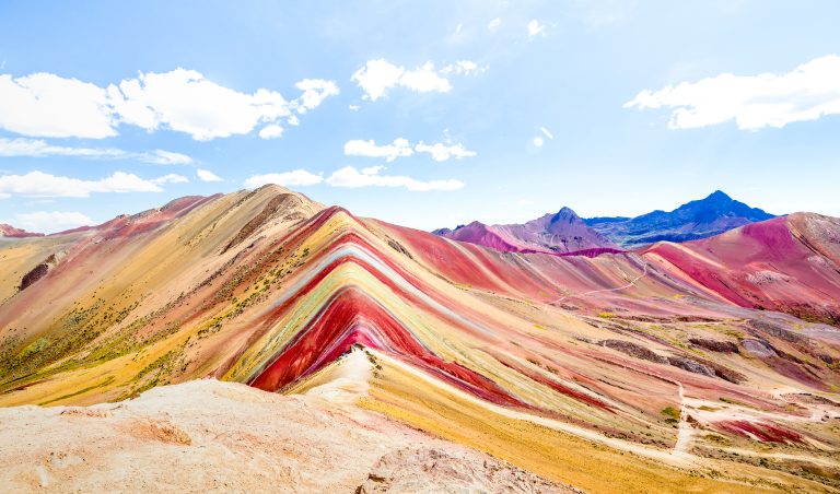Panoramic view of Rainbow Mountain at Vinicunca mount in Peru - Travel and wanderlust concept exploring world nature wonders - Vivid multicolor filter with bright enhanced color tones