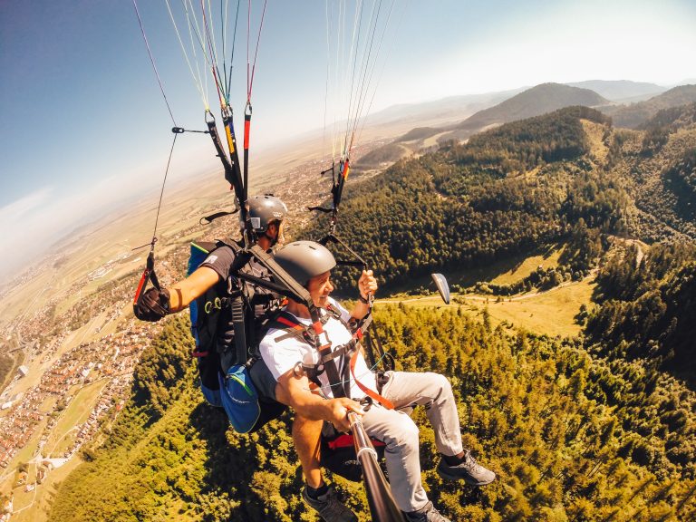 paragliding-above-verdant-forest-landscape-on-sunn-2026-03-09-03-25-57-utc