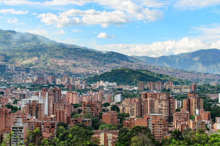 red-brick-buildings-on-lush-green-mountains-under-2026-03-17-00-41-45-utc