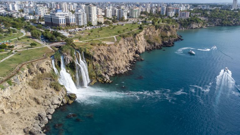 Waterfall Duden (Karpuzkaldiran selalesi) falling into the Mediterranean sea. Waterfall falling into sea. Waterfall stream. Aerial drone shooting. Antalya - Turkey